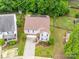 Aerial view of a two-story home with a driveway, backyard deck, and well-maintained landscaping at 2306 Nettleton Ct, Matthews, NC 28105