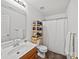 Clean and well-maintained bathroom featuring a wooden vanity, shower, and functional shelving at 2306 Nettleton Ct, Matthews, NC 28105