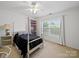 Bright bedroom with a four-poster bed, ceiling fan, and large windows offering an abundance of natural light at 2306 Nettleton Ct, Matthews, NC 28105