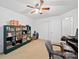 Well-lit bedroom with a ceiling fan, built-in shelving, and plenty of space, perfect for relaxation and work at 2306 Nettleton Ct, Matthews, NC 28105
