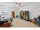 Spacious room with a ceiling fan, built-in shelves, and a large desk, suitable for many different uses at 2306 Nettleton Ct, Matthews, NC 28105
