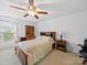 Inviting bedroom with a floral patterned bed, a ceiling fan, and a desk, offering a peaceful retreat at 2306 Nettleton Ct, Matthews, NC 28105