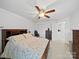Bright bedroom featuring a floral bed set, a ceiling fan, and a double closet for ample storage at 2306 Nettleton Ct, Matthews, NC 28105