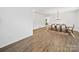 Spacious dining area with wood-look floors, a chandelier, and table set for six underneath at 2306 Nettleton Ct, Matthews, NC 28105