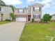 Lovely two-story home with a two car garage, well-kept lawn, and nicely landscaped flower beds at 2306 Nettleton Ct, Matthews, NC 28105
