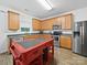 Well-lit kitchen with stainless steel appliances, wood cabinets, and a functional center island at 2306 Nettleton Ct, Matthews, NC 28105