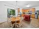 Eat-in kitchen featuring stainless steel appliances, wood cabinets, and access to an outdoor patio at 2306 Nettleton Ct, Matthews, NC 28105