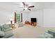 Bright living room with a ceiling fan, comfortable seating, and large window offering ample natural light at 2306 Nettleton Ct, Matthews, NC 28105