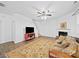 Comfortable living room area with a media center and a decorative fireplace at 2306 Nettleton Ct, Matthews, NC 28105