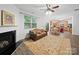 Cozy living room features fireplace, ceiling fan, and adjoins kitchen with breakfast nook at 2306 Nettleton Ct, Matthews, NC 28105