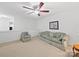 Cozy living room featuring a ceiling fan and comfortable green sofa, great for relaxing and entertaining at 2306 Nettleton Ct, Matthews, NC 28105