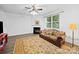 Inviting living room featuring a classic fireplace, sofa, and decorative rug at 2306 Nettleton Ct, Matthews, NC 28105