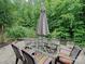 Outdoor patio features a glass dining table with six chairs and a closed umbrella for shade at 2306 Nettleton Ct, Matthews, NC 28105