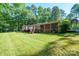 Picture of a backyard with a nice lawn and large trees surrounding the property at 2310 Alexis Lucia Rd, Stanley, NC 28164