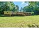 Expansive backyard featuring a spacious deck, mature trees, and lush greenery at 2310 Alexis Lucia Rd, Stanley, NC 28164