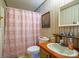 This cozy bathroom features an orange vanity and striped wallpaper at 2310 Alexis Lucia Rd, Stanley, NC 28164