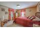 Well-lit bedroom with closet, side table, and two windows at 2310 Alexis Lucia Rd, Stanley, NC 28164