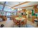 Inviting dining area with wooden beams, a chandelier, and open access to the living room and kitchen at 2310 Alexis Lucia Rd, Stanley, NC 28164