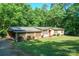 Charming single-story home with a lush green lawn and a carport, perfect for suburban living at 2310 Alexis Lucia Rd, Stanley, NC 28164