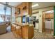Kitchen features wood breakfast bar with seating and laminate floor; view into living room at 2310 Alexis Lucia Rd, Stanley, NC 28164