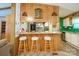 Eat-in kitchen features wood paneled breakfast bar with seating and view of stainless appliances at 2310 Alexis Lucia Rd, Stanley, NC 28164