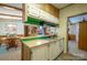 Kitchen boasts laminate floors and breakfast bar with view of eat-in kitchen and living room at 2310 Alexis Lucia Rd, Stanley, NC 28164