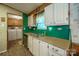 Kitchen showcases white cabinets, laminate countertop, stainless sink, and view into laundry at 2310 Alexis Lucia Rd, Stanley, NC 28164