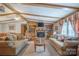 Cozy living room with wood beams, a stone fireplace, built-in shelving, and comfortable seating at 2310 Alexis Lucia Rd, Stanley, NC 28164