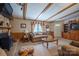 Comfortable living room with stone fireplace, exposed beams, and neutral decor, creating a warm and inviting atmosphere at 2310 Alexis Lucia Rd, Stanley, NC 28164