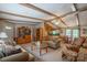 Open-concept living space featuring exposed beams, comfortable seating, and seamless flow to the kitchen and dining area at 2310 Alexis Lucia Rd, Stanley, NC 28164