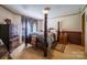 Spacious main bedroom featuring a four poster bed, sitting area, and closet at 2310 Alexis Lucia Rd, Stanley, NC 28164