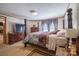 Main bedroom with four poster bed, sitting area, and wall-mounted television at 2310 Alexis Lucia Rd, Stanley, NC 28164