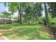 Lush backyard with mature trees offering shade and privacy for outdoor enjoyment and relaxation at 2409 Thornton Rd, Charlotte, NC 28208