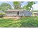 A single-story home with a fenced backyard and a patio with a door to the home at 2409 Thornton Rd, Charlotte, NC 28208
