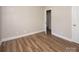 Bright bedroom featuring new floors, a door to the hallway, and neutral walls at 2409 Thornton Rd, Charlotte, NC 28208