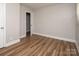 Inviting bedroom with new flooring, a window providing natural light, and neutral decor at 2409 Thornton Rd, Charlotte, NC 28208