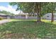 A cozy single-story home featuring a well-maintained lawn and mature shade trees at 2409 Thornton Rd, Charlotte, NC 28208
