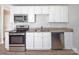 Updated kitchen featuring white cabinets, stainless steel appliances, and granite countertops at 2409 Thornton Rd, Charlotte, NC 28208