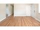 Large living room featuring beautiful wood floors and neutral colored walls at 2409 Thornton Rd, Charlotte, NC 28208