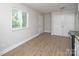 Bright living room with new floors and a large window allowing ample natural light at 2409 Thornton Rd, Charlotte, NC 28208