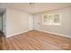 Spacious living room with wood floors, neutral walls, and bright light at 2409 Thornton Rd, Charlotte, NC 28208