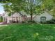Spacious backyard with lush green lawn and covered patio perfect for outdoor entertaining at 2410 Vernon Dr, Charlotte, NC 28211