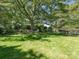Expansive backyard featuring mature trees, a hammock, and seating near the fence at 2410 Vernon Dr, Charlotte, NC 28211