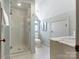 Bright bathroom featuring a glass shower, white tile, and a modern vanity at 2410 Vernon Dr, Charlotte, NC 28211