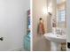 Charming bathroom boasts pedestal sink, towel hanger, and linen shelves to maximize functionality and storage at 2410 Vernon Dr, Charlotte, NC 28211