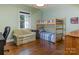 Bedroom with hardwood floors, bunkbeds, and large window providing plenty of natural light at 2410 Vernon Dr, Charlotte, NC 28211
