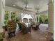 Covered back patio with seating area, fans, and view of the garage and basketball hoop at 2410 Vernon Dr, Charlotte, NC 28211