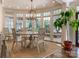 Sunlit dining area features a round table, large windows, and hardwood floors at 2410 Vernon Dr, Charlotte, NC 28211
