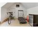 Angled ceiling exercise room with treadmill, bicycle, and mini-fridge at 2410 Vernon Dr, Charlotte, NC 28211