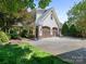 Two-story home with a well-manicured lawn and a two-car garage with basketball hoop at 2410 Vernon Dr, Charlotte, NC 28211